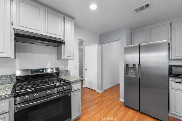 3611 Jupiter Ave, Palmdale, CA 93550 - kitchen featuring appliances with stainless steel finishes, under cabinet range hood, light wood-type flooring, light stone counters, and recessed lighting