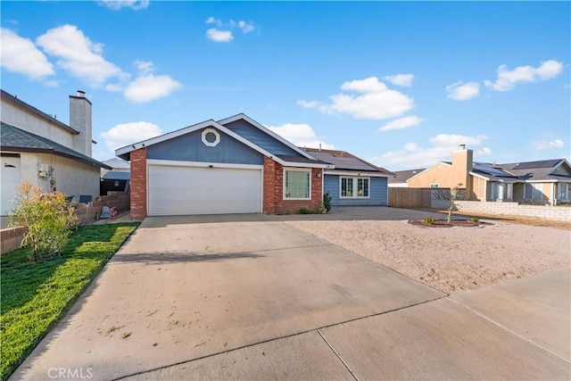 3611 Jupiter Ave, Palmdale, CA 93550 - view of front of property featuring an attached garage, driveway, brick siding, and solar panels