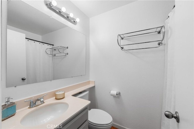 3611 Jupiter Ave, Palmdale, CA 93550 - bathroom with vanity, toilet, and baseboards