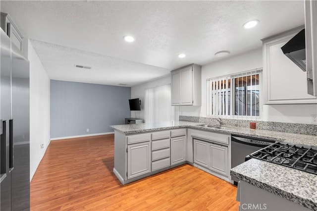 3611 Jupiter Ave, Palmdale, CA 93550 - kitchen featuring gray cabinetry, stainless steel built in fridge, a textured ceiling, a peninsula, and light wood-style flooring