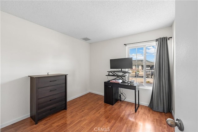 3611 Jupiter Ave, Palmdale, CA 93550 - home office featuring wood finished floors, a textured ceiling, and baseboards