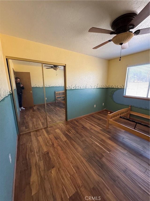 18515 Kalin Ranch Dr, Victorville, CA 92395 - unfurnished bedroom with wood finished floors, ceiling fan, a textured ceiling, and a closet