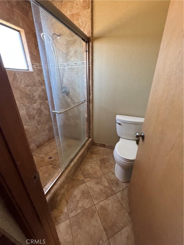 18515 Kalin Ranch Dr, Victorville, CA 92395 - full bathroom with toilet, a stall shower, and tile patterned floors