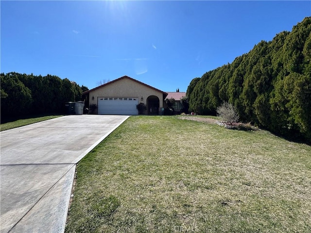 18515 Kalin Ranch Dr, Victorville, CA 92395 - single story home featuring an attached garage, a front yard, driveway, stucco siding, and a wooded view