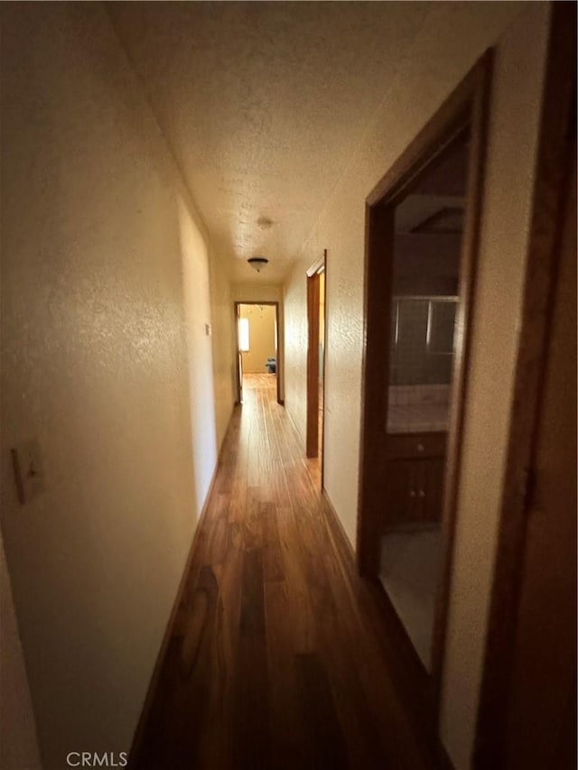 18515 Kalin Ranch Dr, Victorville, CA 92395 - corridor with wood finished floors, a textured ceiling, and a textured wall