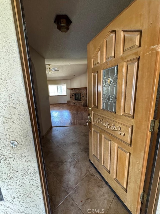 18515 Kalin Ranch Dr, Victorville, CA 92395 - corridor with a textured ceiling and dark tile patterned floors