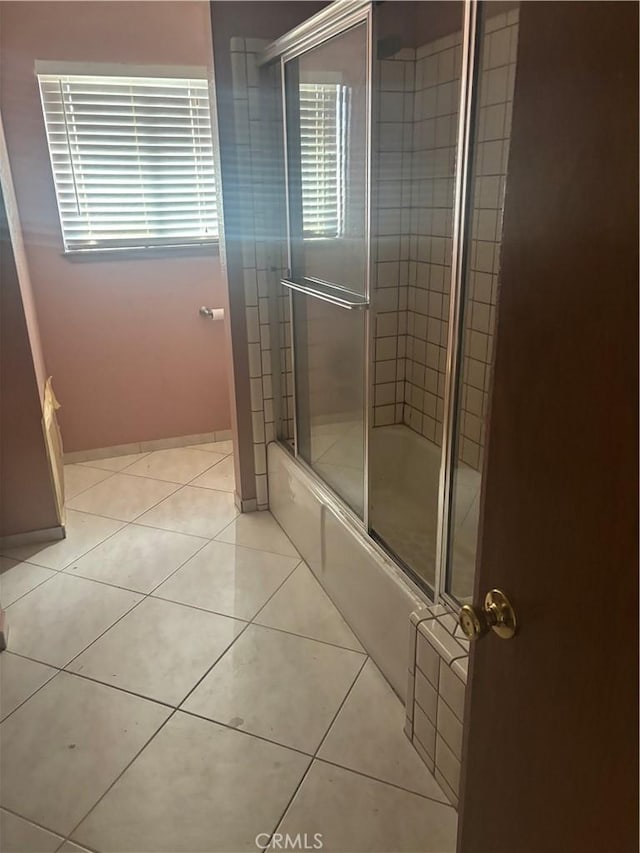 18515 Kalin Ranch Dr, Victorville, CA 92395 - full bath featuring tile patterned floors, shower / bath combination with glass door, and baseboards