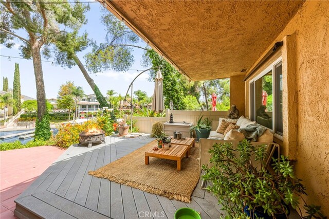 24311 Canyon Lake Dr N Unit 12, Canyon Lake, CA 92587 - wooden terrace featuring an outdoor living space with a fire pit and a patio area