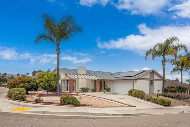 16182 Selva Dr, San Diego, CA 92128 - view of front facade with solar panels, a garage, concrete driveway, and stucco siding