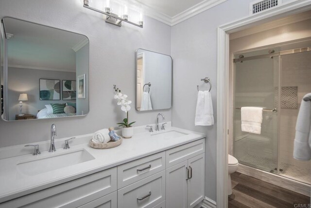 16182 Selva Dr, San Diego, CA 92128 - bathroom with ornamental molding, toilet, double vanity, a shower stall, and connected bathroom