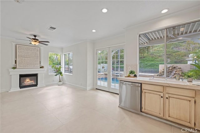 25605 Wordsworth Ln, Stevenson Ranch, CA 91381 - kitchen with stainless steel dishwasher, light brown cabinets, light countertops, crown molding, and ceiling fan