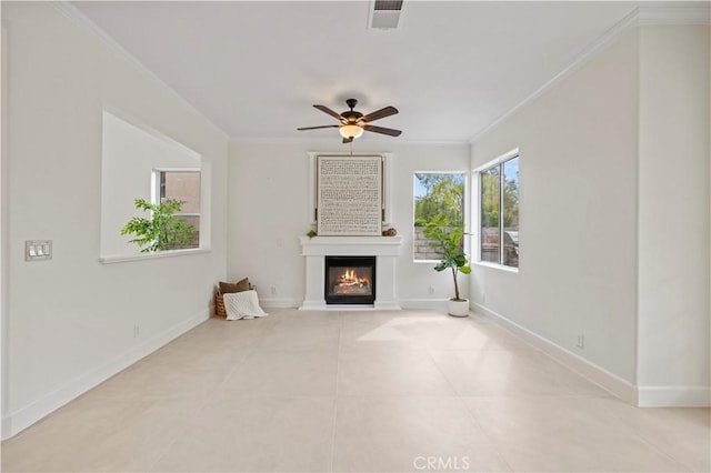25605 Wordsworth Ln, Stevenson Ranch, CA 91381 - unfurnished living room with ornamental molding, a glass covered fireplace, ceiling fan, tile patterned flooring, and baseboards