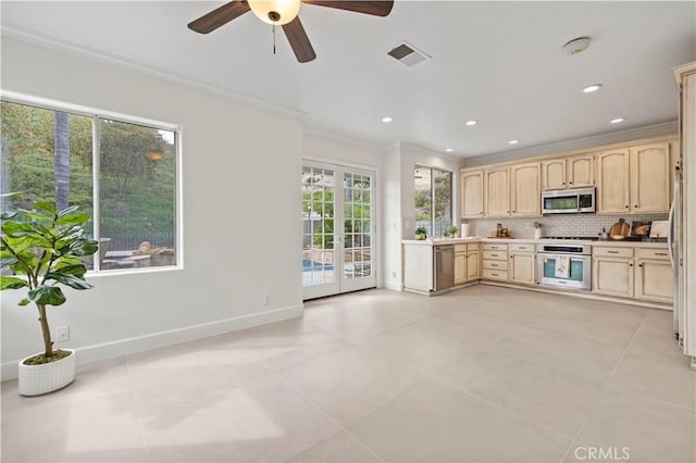 25605 Wordsworth Ln, Stevenson Ranch, CA 91381 - kitchen with appliances with stainless steel finishes, crown molding, light brown cabinetry, plenty of natural light, and decorative backsplash
