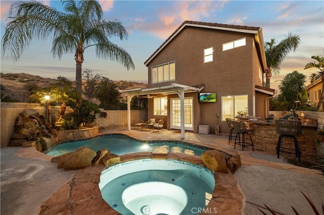 25605 Wordsworth Ln, Stevenson Ranch, CA 91381 - back of property with a fenced backyard, stucco siding, french doors, a pool with connected hot tub, and a patio