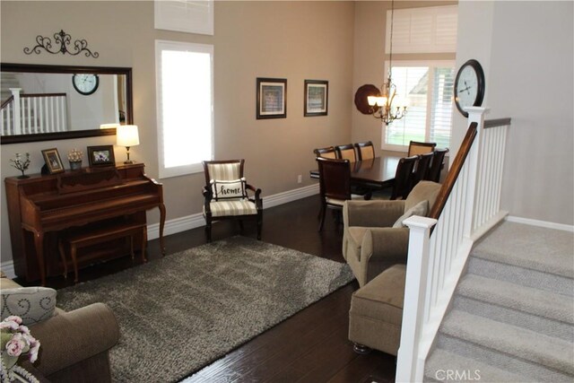 1338 Coral Gables Cir, Corona, CA 92881 - living area featuring stairway, baseboards, a chandelier, dark wood-type flooring, and healthy amount of natural light