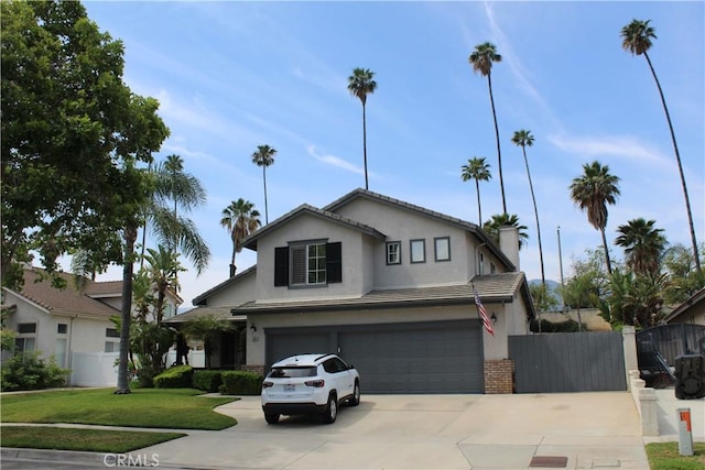 1338 Coral Gables Cir, Corona, CA 92881 - traditional-style house featuring a garage, driveway, stucco siding, and a chimney