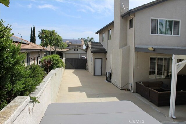 1338 Coral Gables Cir, Corona, CA 92881 - view of home's exterior featuring stucco siding, a gate, a tile roof, a patio area, and a residential view