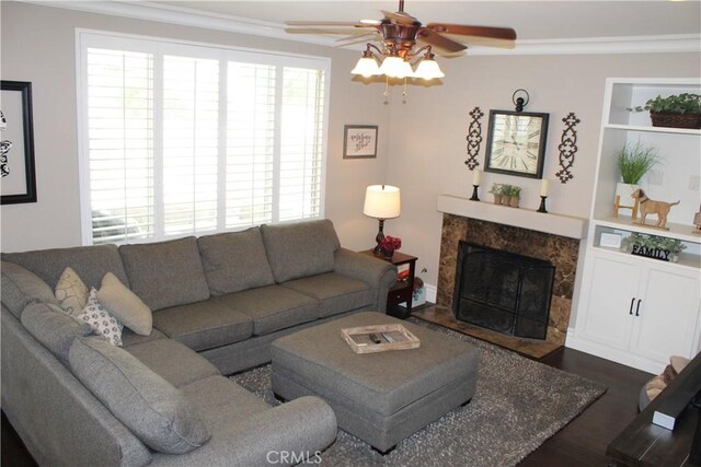 1338 Coral Gables Cir, Corona, CA 92881 - living room with a ceiling fan, ornamental molding, plenty of natural light, a premium fireplace, and dark wood-style floors
