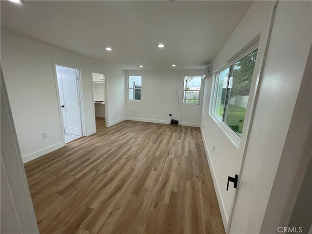 11431 Lee Ln, El Monte, CA 91731 - empty room with recessed lighting, light wood-style flooring, baseboards, and a wall mounted air conditioner