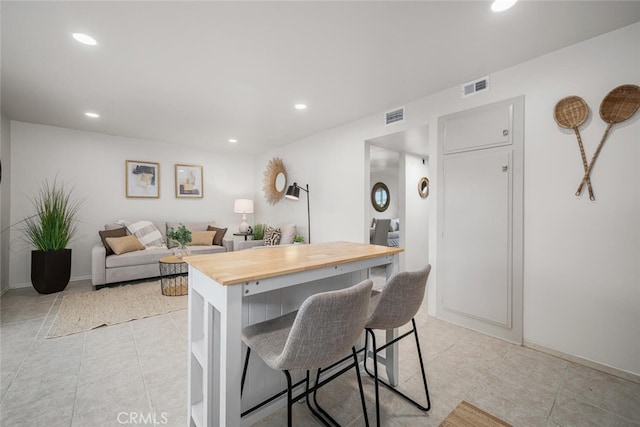 4057 Via Encinas, Cypress, CA 90630 - kitchen featuring wood counters, a breakfast bar area, recessed lighting, and light tile patterned floors
