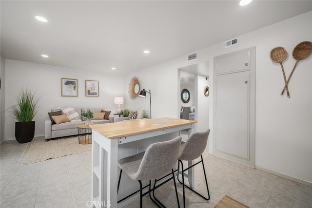 4057 Via Encinas, Cypress, CA 90630 - kitchen featuring butcher block counters, a kitchen bar, recessed lighting, and light tile patterned floors