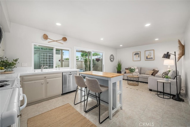 4057 Via Encinas, Cypress, CA 90630 - kitchen with stainless steel dishwasher, white range, recessed lighting, light tile patterned floors, and butcher block counters