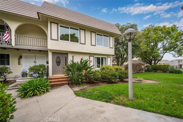 4057 Via Encinas, Cypress, CA 90630 - multi unit property featuring a balcony, stucco siding, and a front lawn