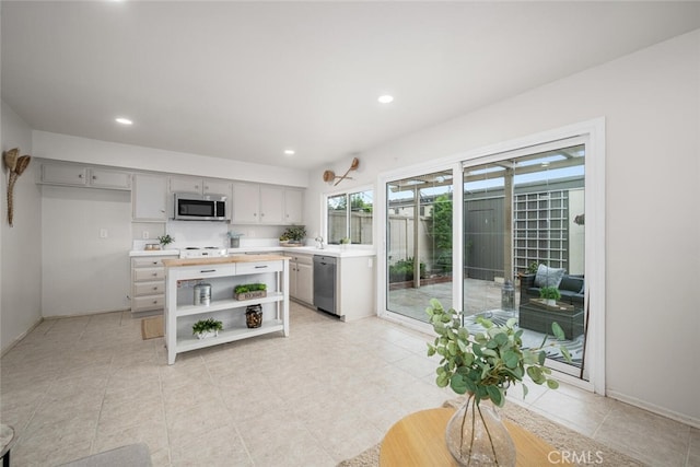 4057 Via Encinas, Cypress, CA 90630 - kitchen featuring appliances with stainless steel finishes, open shelves, recessed lighting, light tile patterned flooring, and gray cabinetry