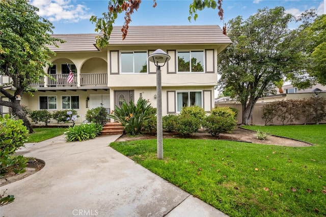 4057 Via Encinas, Cypress, CA 90630 - view of front facade with a balcony, stucco siding, and a front yard