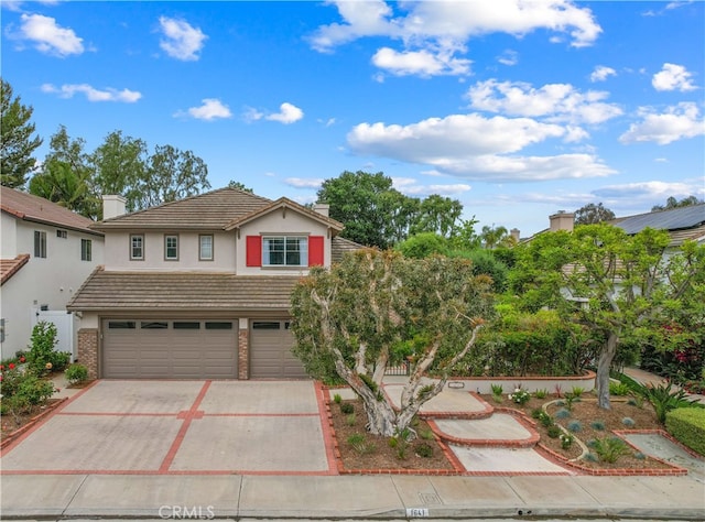 1641 Via Tulipan, San Clemente, CA 92673 - traditional home featuring an attached garage, driveway, stucco siding, a tiled roof, and a chimney
