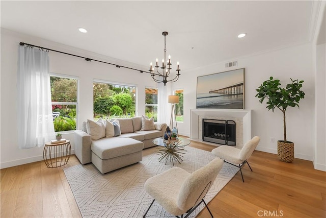 1641 Via Tulipan, San Clemente, CA 92673 - living room featuring baseboards, light wood-style flooring, a chandelier, recessed lighting, and a premium fireplace