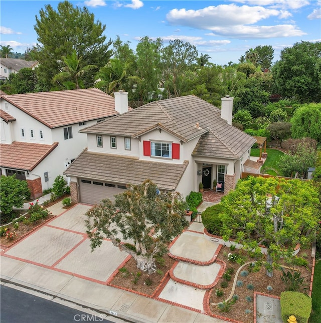 1641 Via Tulipan, San Clemente, CA 92673 - view of front facade featuring a chimney, driveway, stucco siding, and a tile roof