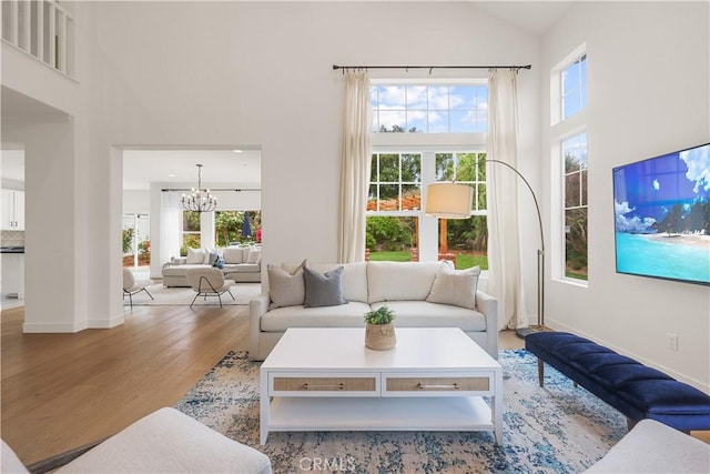 1641 Via Tulipan, San Clemente, CA 92673 - living room with high vaulted ceiling, a chandelier, healthy amount of natural light, wood finished floors, and baseboards