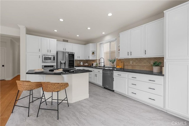 1641 Via Tulipan, San Clemente, CA 92673 - kitchen with stainless steel appliances, open shelves, a kitchen breakfast bar, dark countertops, and white cabinets