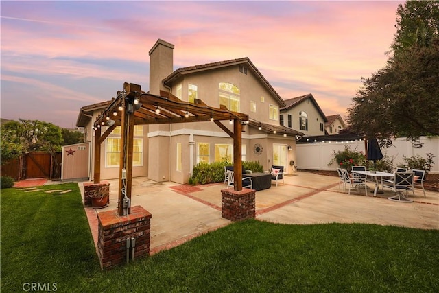 1641 Via Tulipan, San Clemente, CA 92673 - back of house at dusk featuring a pergola, a chimney, a patio area, and stucco siding