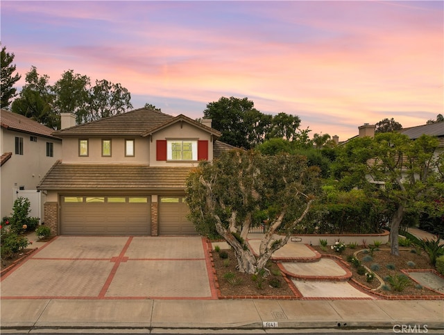 1641 Via Tulipan, San Clemente, CA 92673 - traditional home with decorative driveway, an attached garage, a tiled roof, and stucco siding