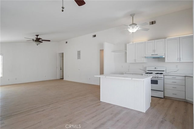 29582 Toomas Cir, Menifee, CA 92587 - kitchen featuring ceiling fan, white gas range, under cabinet range hood, light countertops, and light wood-type flooring
