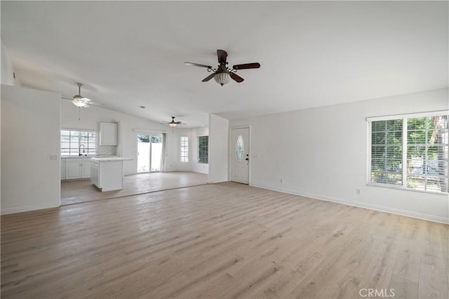 29582 Toomas Cir, Menifee, CA 92587 - unfurnished living room with light wood-type flooring, baseboards, ceiling fan, and vaulted ceiling