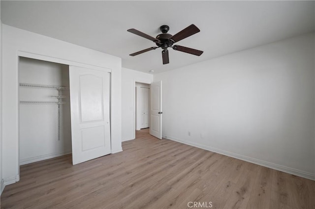 29582 Toomas Cir, Menifee, CA 92587 - unfurnished bedroom with light wood finished floors, a closet, baseboards, and a ceiling fan