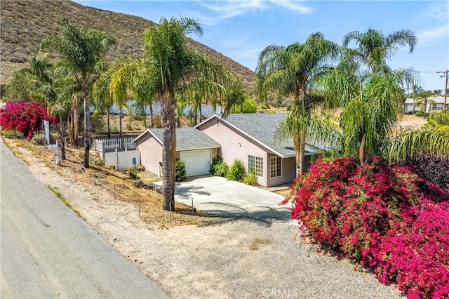 29582 Toomas Cir, Menifee, CA 92587 - view of front of property featuring driveway, stucco siding, and a mountain view