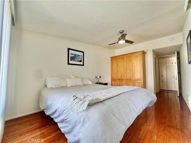 13721 El Dorado Dr Unit M3-K, Seal Beach, CA 90740 - bedroom with hardwood / wood-style flooring, a textured ceiling, baseboards, and ceiling fan