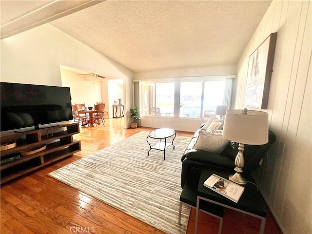 13721 El Dorado Dr Unit M3-K, Seal Beach, CA 90740 - living area featuring wood finished floors, a textured ceiling, and vaulted ceiling