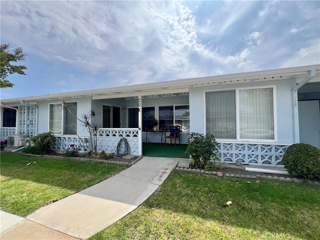 13721 El Dorado Dr Unit M3-K, Seal Beach, CA 90740 - view of front of property with a front lawn, covered porch, and stucco siding