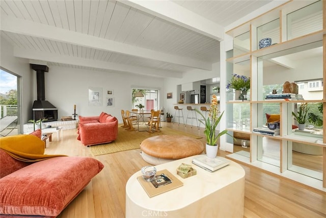 3102 Durand Dr, Los Angeles, CA 90068 - living area with wood finished floors, beam ceiling, a wood stove, and plenty of natural light