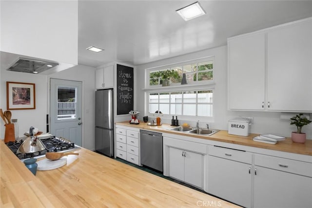 3102 Durand Dr, Los Angeles, CA 90068 - kitchen featuring stainless steel appliances, a sink, wood counters, and white cabinets