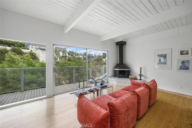 3102 Durand Dr, Los Angeles, CA 90068 - living room with a wood stove, wood finished floors, wood ceiling with exposed beams, and baseboards
