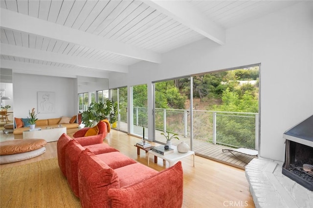 3102 Durand Dr, Los Angeles, CA 90068 - living area featuring beam ceiling, healthy amount of natural light, wood finished floors, and a fireplace