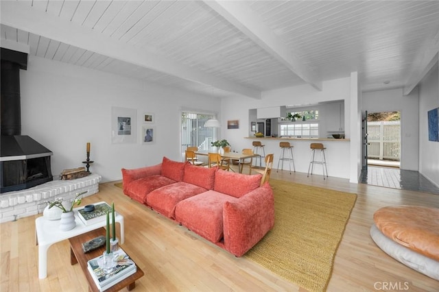 3102 Durand Dr, Los Angeles, CA 90068 - living area featuring beamed ceiling, wood finished floors, and a wood stove