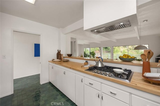 3102 Durand Dr, Los Angeles, CA 90068 - kitchen featuring custom exhaust hood, baseboards, beam ceiling, stainless steel gas stovetop, and white cabinets