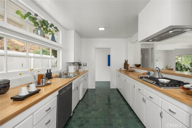 3102 Durand Dr, Los Angeles, CA 90068 - kitchen featuring appliances with stainless steel finishes, wood counters, custom range hood, a sink, and white cabinets